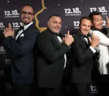 A group of men wearing suits posing for a photo at an unspecified location.